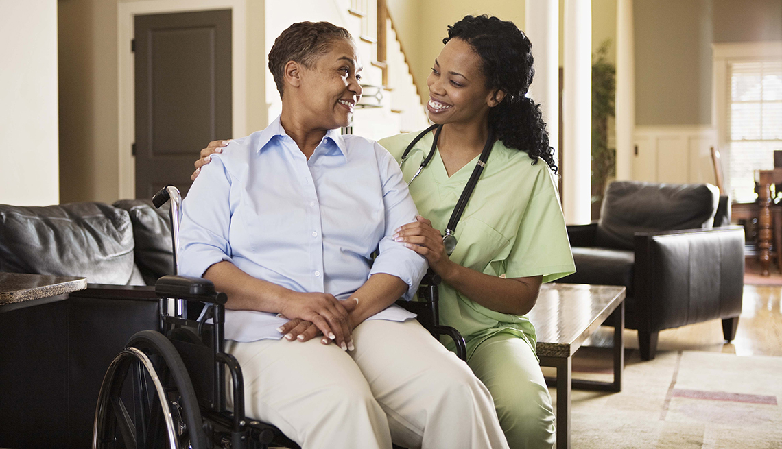 Compassionate caregiver helping a patient at home